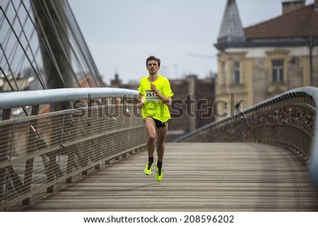 KRAKOW, POLAND - MAR 23, 2014: Unidentified participants during the annual Krakow international Marathon. Krakow Marathon conducted since 2002 under the slogan: With history in the background.