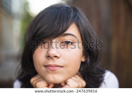 Close-up portrait of beautiful teen girl on the street.