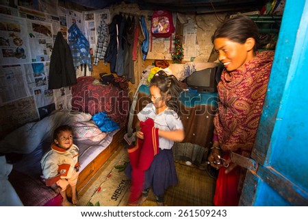 KATHMANDU, NEPAL - CIRCA DEC, 2013: Unidentified local people in a house in a poor area of the city. The caste system is still intact today but the rules are not as rigid as they were in the past.