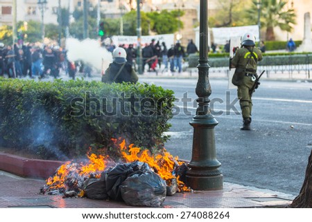 ATHENS, GREECE - APR 16, 2015: Leftist and anarchist groups seeking the abolition of new maximum security prisons, clashed with riot police, who responded with tear gas and stun grenades.