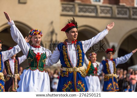 KRAKOW, POLAND - MAY 3, 2015: Polish folk collective on Main square during annual Polish national and public holiday the Constitution Day - May 3, 1791 was adopted first Constitution of modern Europe.