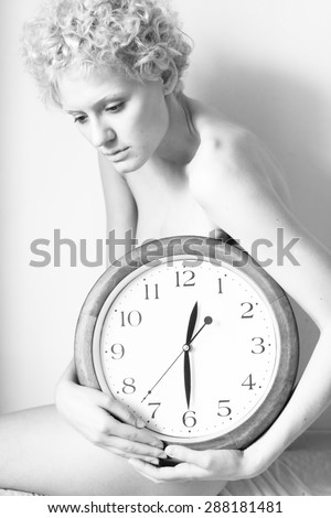 Young gentle woman with big clock . Black and white photography.