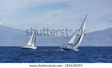 Boats in sailing regatta. Yacht sails with cloudless sky. Luxury yachts.