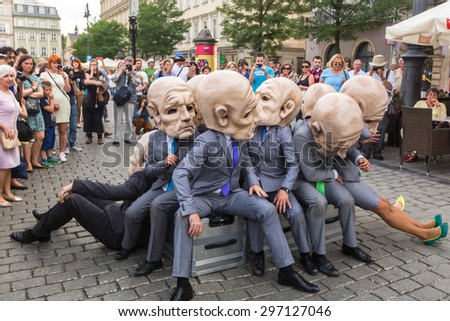 KRAKOW, POLAND - JUL 12, 2015: Participants at the annually (Jul 9-12) 28th International Festival of Street Theatres - Teatr KTO (PL) Peregrinus in Main Square and at random points around the city.