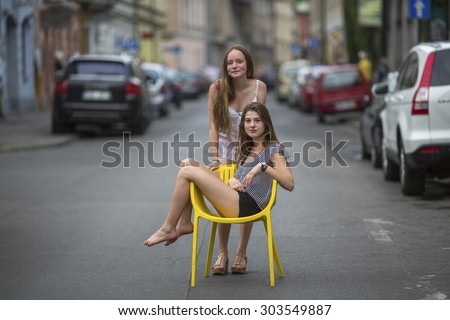 Two young best girlfriends in the old European town.