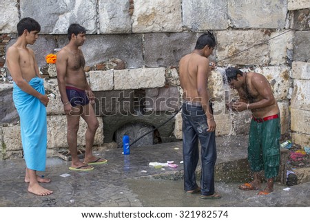 KOS, GREECE - SEP 28, 2015: Unidentified war refugees wash up on the beach. Kos island is located just 4 kilometers from the Turkish coast, and many refugees come from Turkey in an inflatable boats.