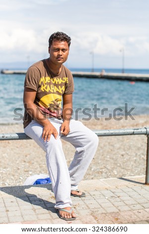 KOS, GREECE - SEP 28, 2015: Unidentified war refugee. More than half are migrants from Syria, but there are refugees from other countries -Afghanistan, Pakistan, Iraq, Iran, Mali, Somalia.