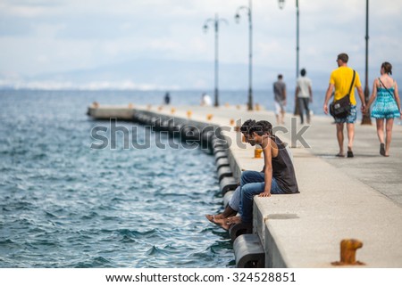 KOS, GREECE - SEP 28, 2015: Unidentified refugees. More than half are migrants from Syria, but there are refugees from other countries - Afghanistan, Pakistan, Iraq, Iran, Mali, Bangladesh, Eritrea.