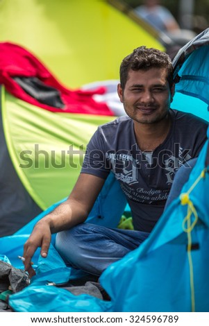KOS, GREECE - SEP 28, 2015: Unidentified refugee near tents. More than half are migrants from Syria, but there are refugees from other countries -Afghanistan, Pakistan, Iraq, Iran, Mali, Eritrea.