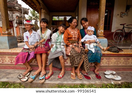 BALI, INDONESIA - MARCH 28: Balinese family after the ceremonies of Oton - is the first ceremony for baby\'s on which the infant is allowed to touch the ground on March 28, 2012 on Bali, Indonesia.