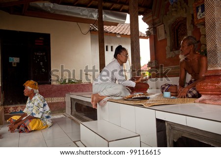 BALI, INDONESIA - MARCH 28: Hindu Brahmin befor the ceremonies of Oton - is the first ceremony for baby\'s on which the infant is allowed to touch the ground on March 28, 2012 on Bali, Indonesia.