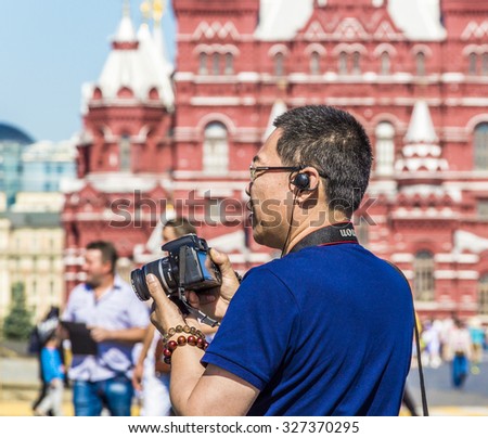 MOSCOW, RUSSIA - JULY 26, 2015: Tourist-photographer on the Red Square