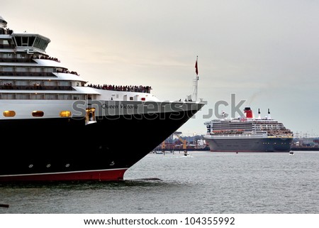 SOUTHAMPTON, UK - 5 JUNE: Cunard ships Queen Mary 2 & Queen Victoria meet in the port of Southampton to join the Queen Elizabeth to celebrate the Diamond Jubilee. 5 JUNE 2012