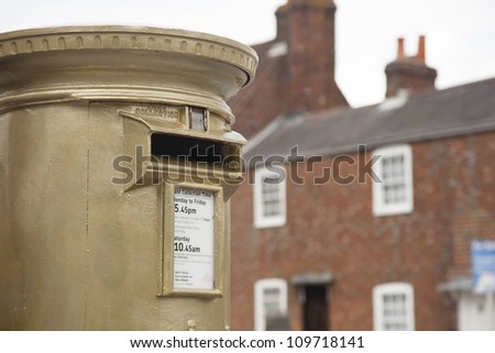 HAMBLE, NR SOUTHAMPTON, UK - AUG 8:UK\'s Royal Mail honors Olympic Gold Medal winners, by transforming a post box from red to gold in the home town of each gold medalist on Aug 8,2012 in Hamble, UK.
