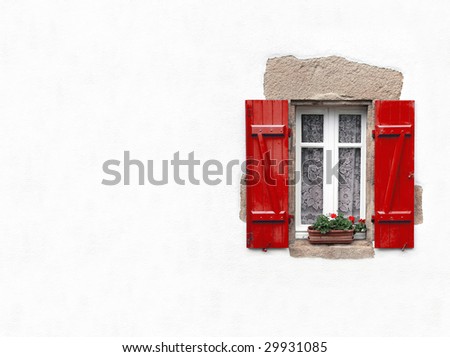 Red shuttered window on white stucco wall with geraniums in window box with copy space