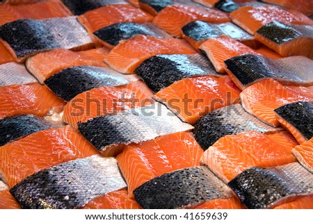 Salmon fillets for sale at a fish market displayed with a patchwork effect