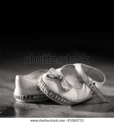 A pair of worn out baby shoes. Nostalgic image suitable for Mothers Day/Fathers Day/Grandparents Day or for birth announcement. Space for your text