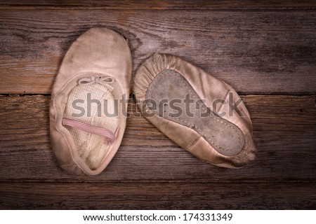 A discarded pair of worn out ballet shoes.Vintage, nostalgic effect suitable for Mother\'s day or Grandparents day.