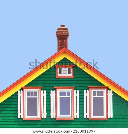 Typical brightly painted exterior of the traditional colourful wooden house of Iles de la Madeleine, or the magdalen Islands, Quebec Province, Canada. Blue sky background with space for text Stock fotó © 