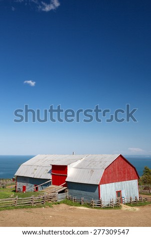Traditional style tin barn overlooking the sea, La Malbaie, Quebec Province, Canada. Space for your text.