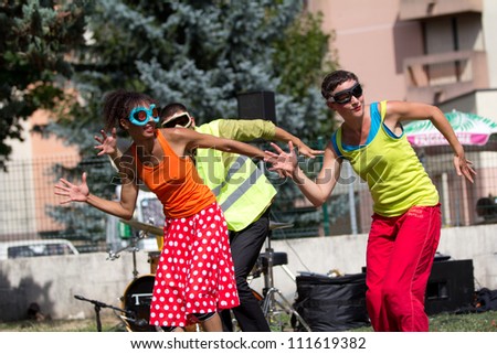 AURILLAC, FRANCE - AUGUST 23: Three dancers in the street as part of the Aurillac International Street Theater Festival,show by the Company Empreintes, on August 23, 2012, in Aurillac,France.