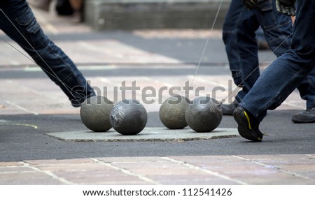 AURILLAC, FRANCE - AUGUST 24: show with four heavy balls on the ground as part of the Aurillac International Street Theater Festival, show New town, on august 24, 2012, in Aurillac,France.