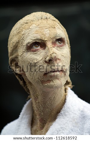 AURILLAC, FRANCE - AUGUST 22: portrait of an actress with the head covered of mud, as part of the Aurillac International Street Theater Festival, on august 22, 2012, in Aurillac,France.