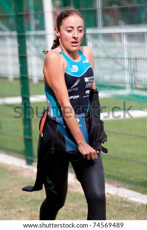 AUCH, FRANCE -  SEPTEMBER 4: Auch triathlon, female runner in the transition area after the swim race, on September 4, 2010, in Auch, France.