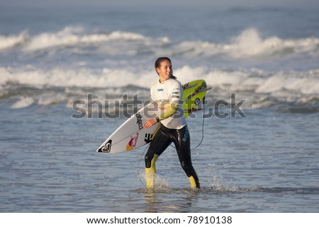 SEIGNOSSE, FRANCE - JUNE 3: Surfer Sally Fitzgibbons walks in the water at the Swatch Pro France on June 3, 2011 in Seignosse, France.