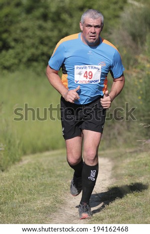 PAVIE, FRANCE - MAY 18: Portrait of an old  runner showing his hands, thumbs up, at the Trail of Pavie, on May 18, 2014, in Pavie, France.