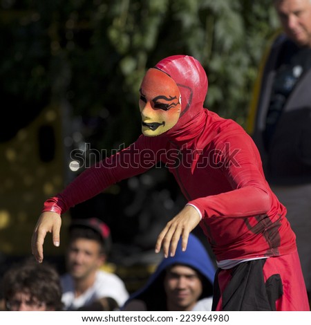 AURILLAC, FRANCE-AUGUST 25: a masked man wearing a red suit dances hip hop as part of the Aurillac International Street Theater Festival, cie Bakhus 24,on august 25, 2014, in Aurillac,France.