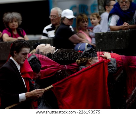 AURILLAC, FRANCE-AUGUST 22: spectators look at the Lenin funeral as part of the Aurillac International Street Theater Festival, cie teatro del silencio there august 22, 2014 in Aurillac, France.