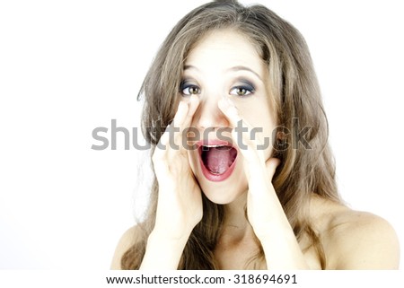 High key portrait of a beautiful young woman on white background. She shouts.  Her hands are around her mouth.