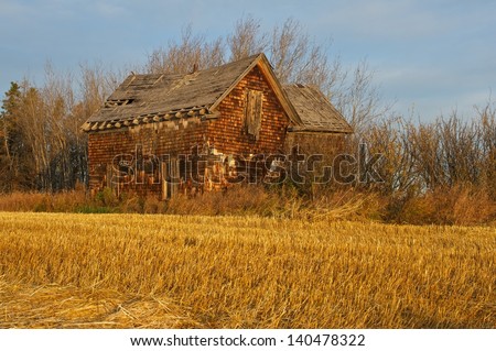 An old abandoned house at sunrise in fall