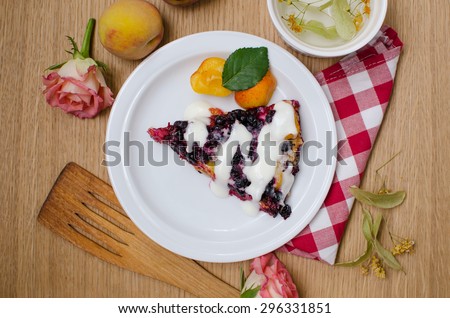 a piece of cake with currants and apricots on the table top