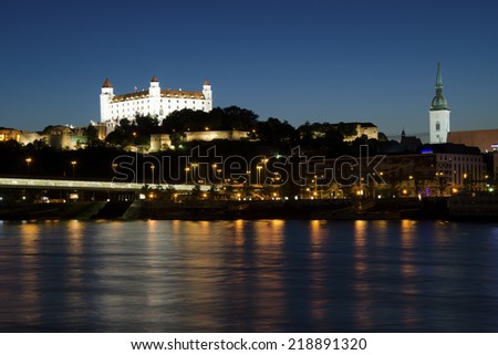BRATISLAVA, SLOVAKIA - JUNE 09, 2014: The night view of Bratislava castle, the cathedral and the Most SNP bridge on Danube with the exposition of photographs.