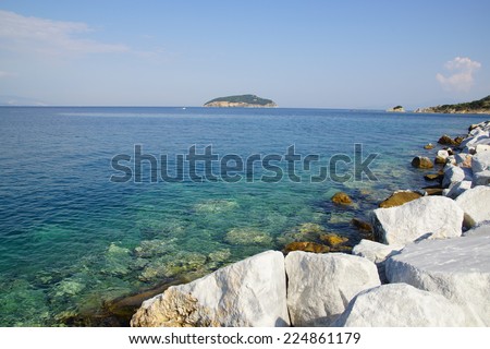 white shiny rocks near the clean blue summer sea
