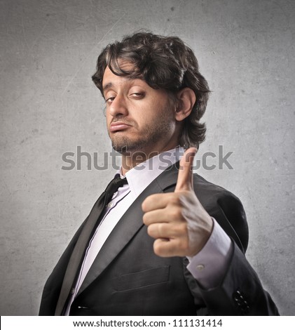 Businessman with satisfied expression and thumbs up