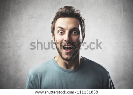 Smiling young man with surprised expression