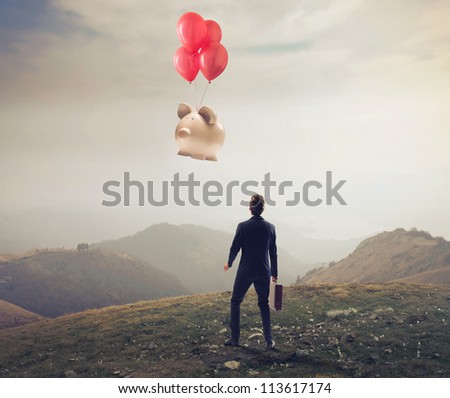 Businessman is losing a big piggy, flying away with some balloons