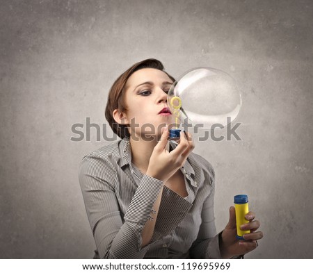Woman making soap bubbles