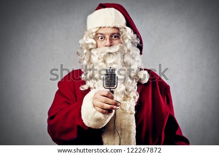Santa Claus holding a vintage microphone