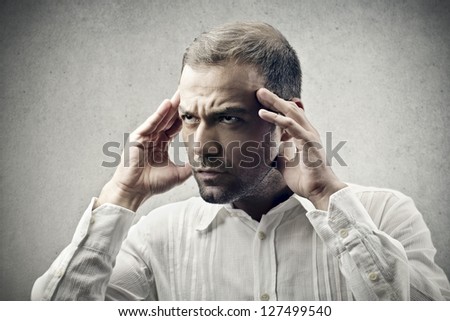 concentrated young man with hands on head