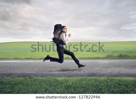 businessman running with backpack on the road