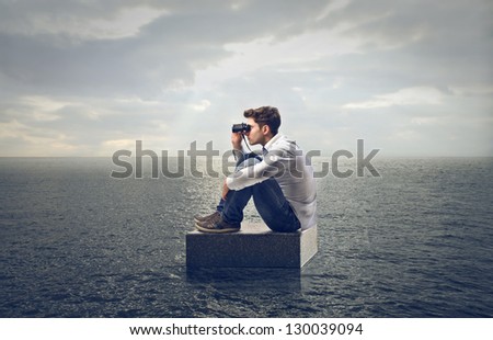 young man looking with binoculars