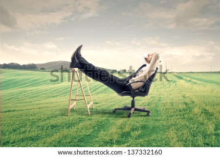 young businessman relaxes sitting outdoor