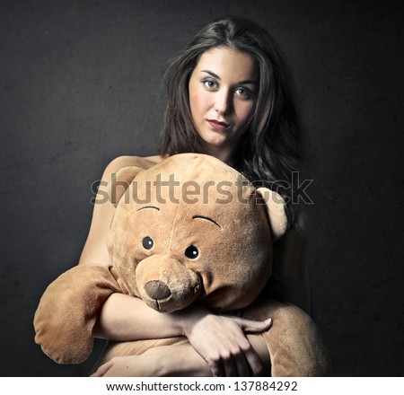 pretty girl embraces big teddy bear