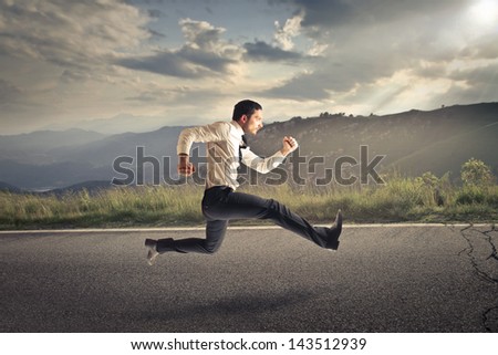 young businessman running on the road