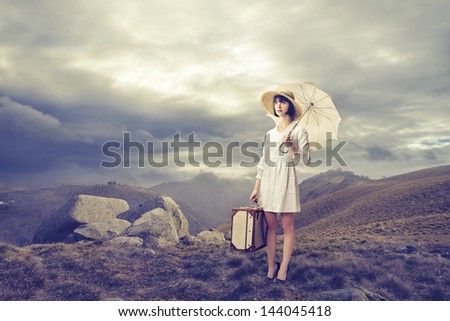 pretty woman dressed in vintage clothing in the mountains