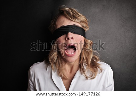 beautiful blindfolded woman screaming with fear